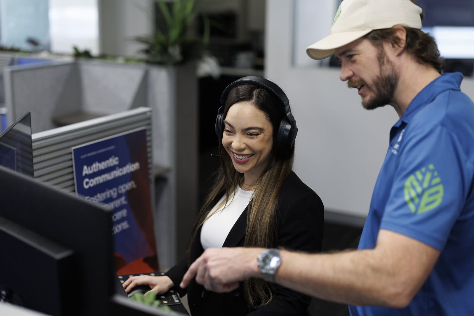 An Elliott Insurance account executive reviewing a client's details with a colleague